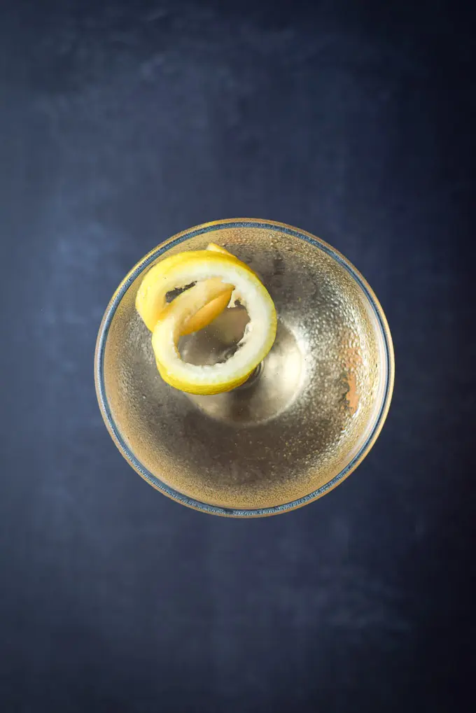 Overhead view of the amber cocktail with the twist floating in it