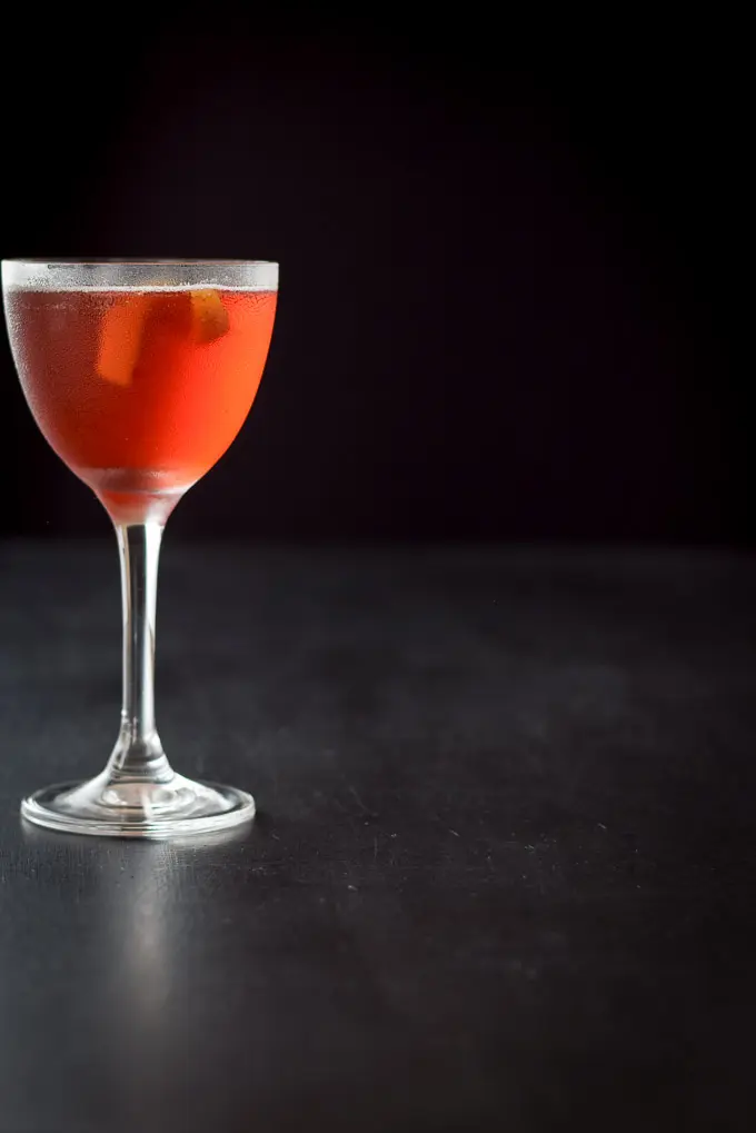 A far away view of the Boulevardier  off to the left on a black background