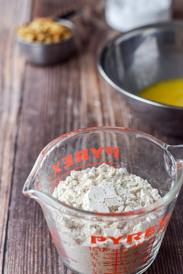Spelt flour, whisked eggs and walnuts on the table