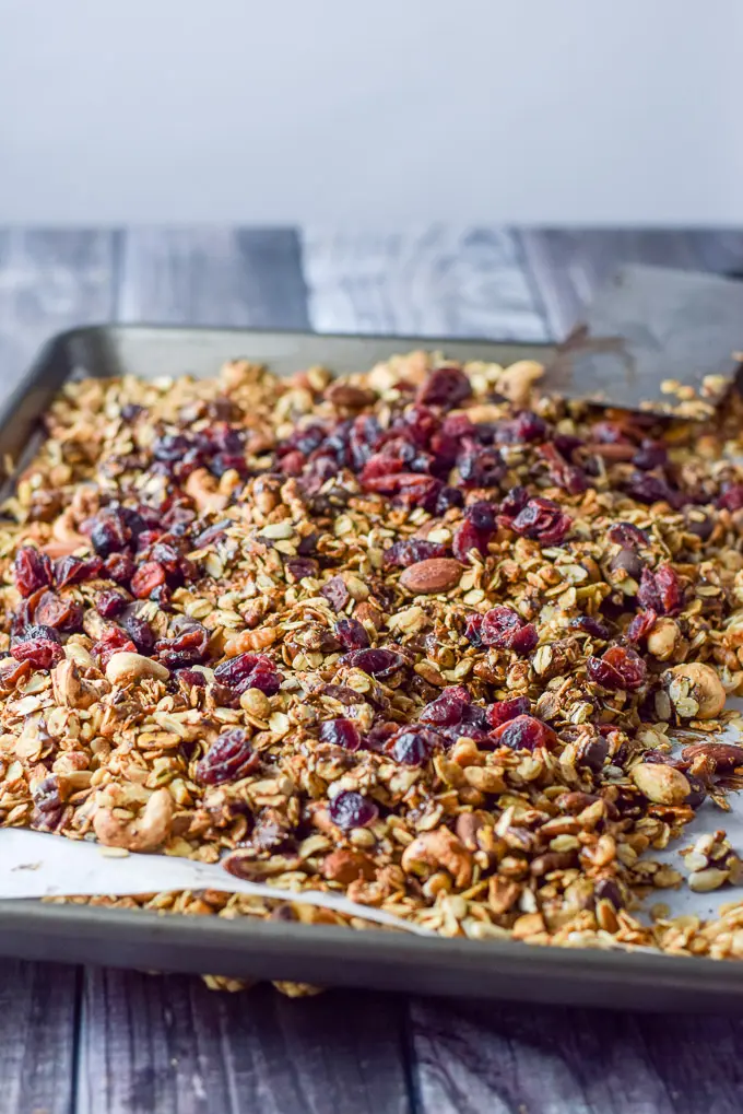 Chocolate mixed in the pan of granola and cranberries on top
