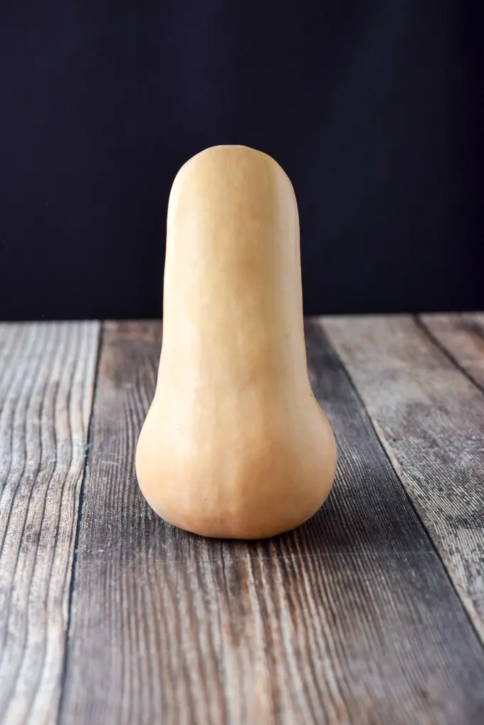 A single squash standing proud and alone on a table