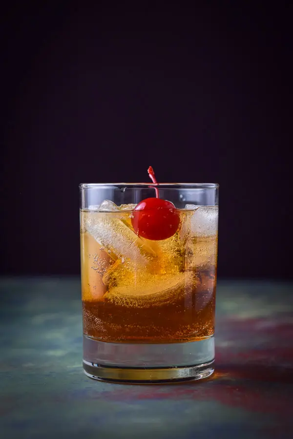 Vertical view of Manhattan with the cherry in the front of the ice cubes