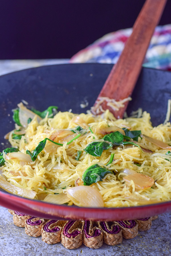 Squash in the wok with all the ingredients, including onion, spinach, butter sauce all mixed together