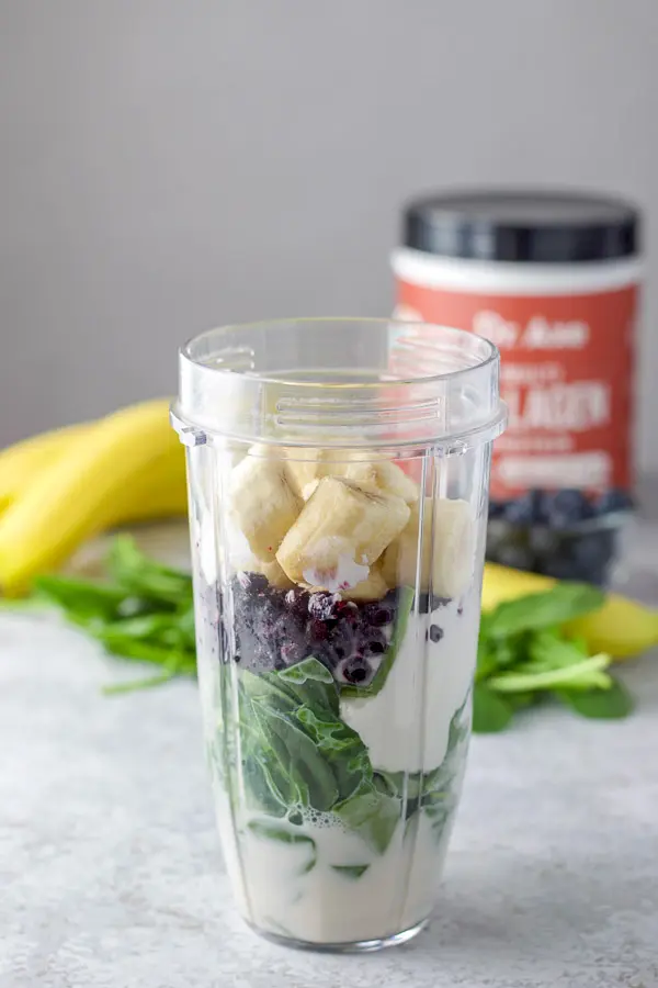 Chopped up banana's, blueberries, spinach, yogurt and almond milk in a blender