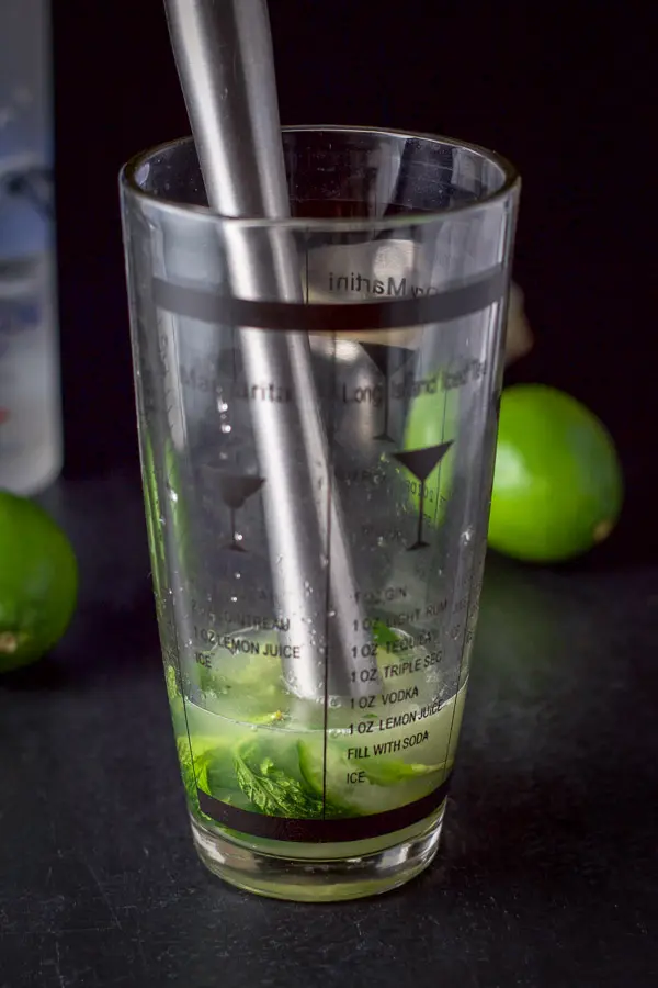 Cucumbers, mint, simple syrup and lime juice muddled in the cocktail shaker