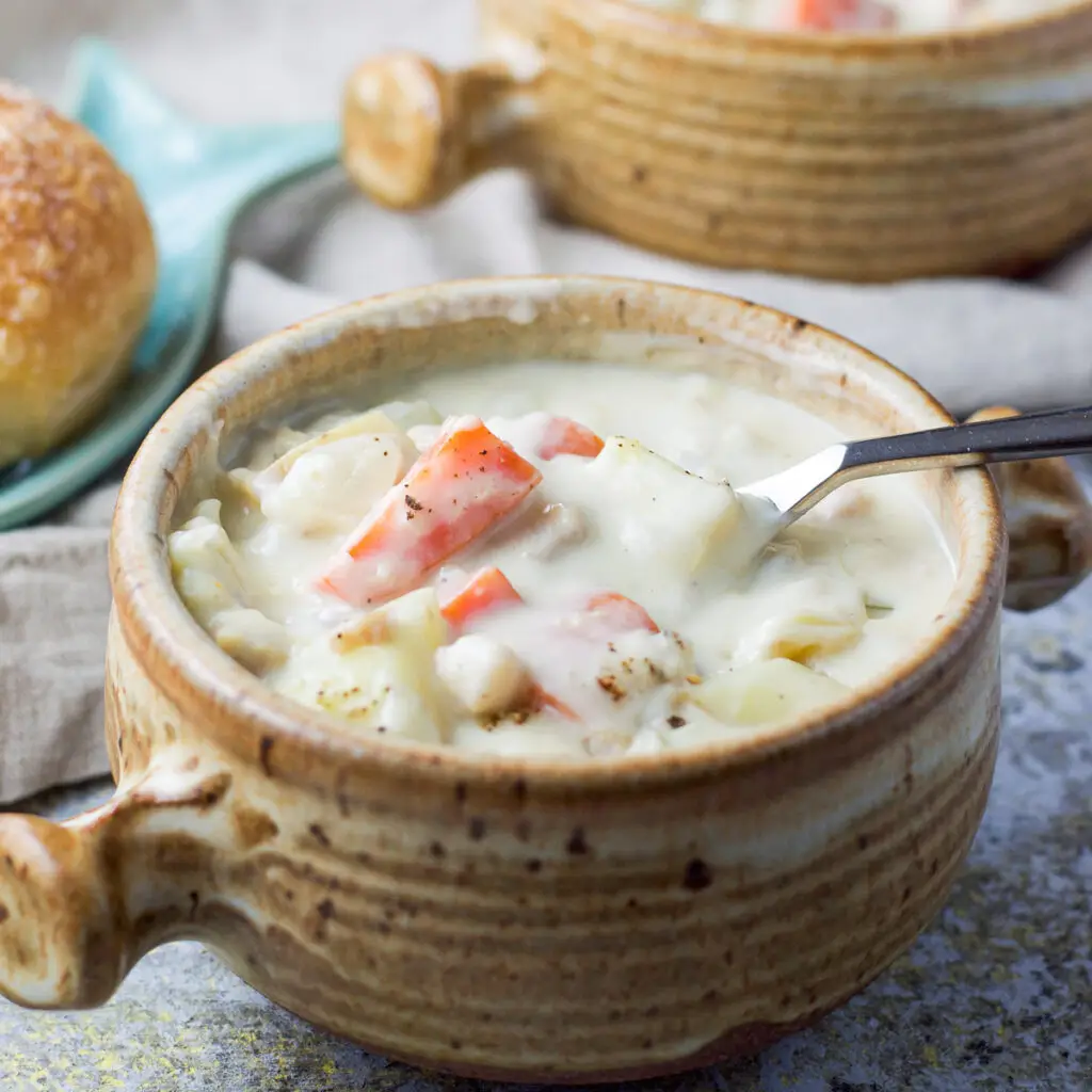 A crock filled with the easy clam chowder - square