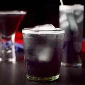 Three purple rain cocktails in vertical view