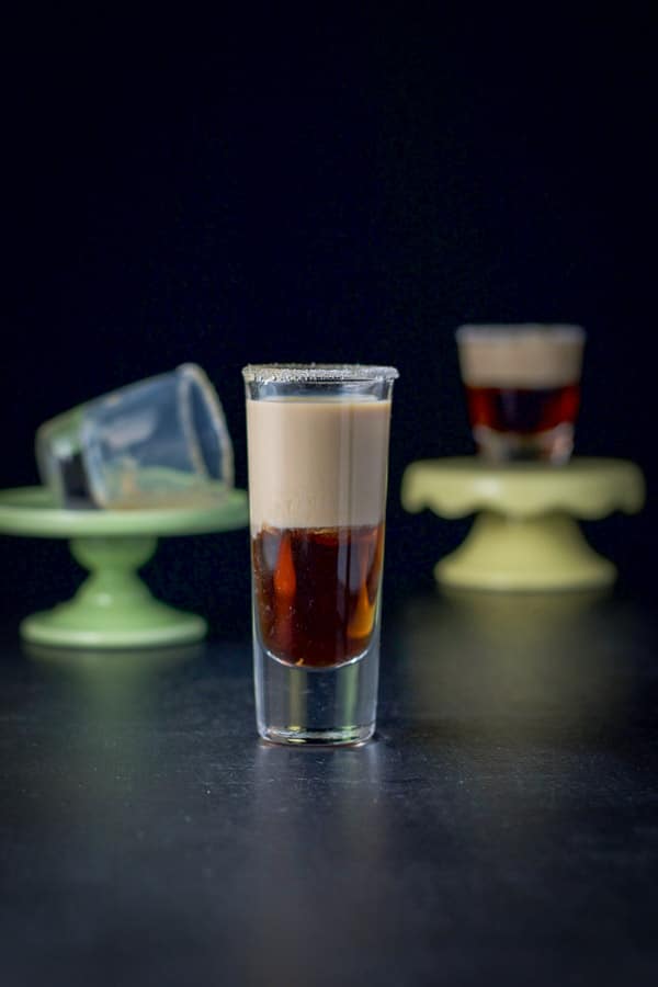 One of the glasses on the pedestal has been imbibed and is tipped on its side. The other shot glasses are still filled with the donut shot