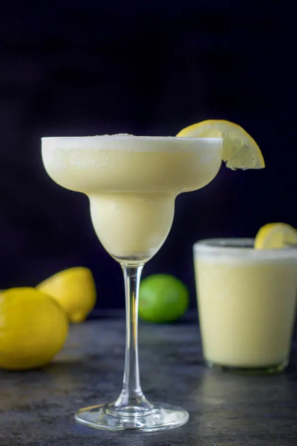 Vertical view of the lemon margarita - tall glass in front