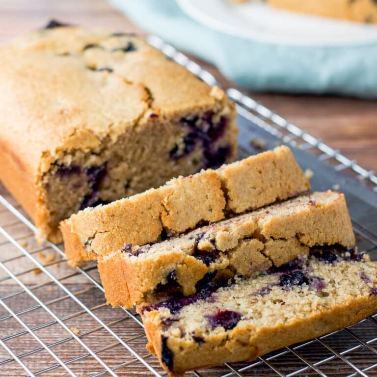 Three slices of bread on a wire rack with the rest of the loaf - square