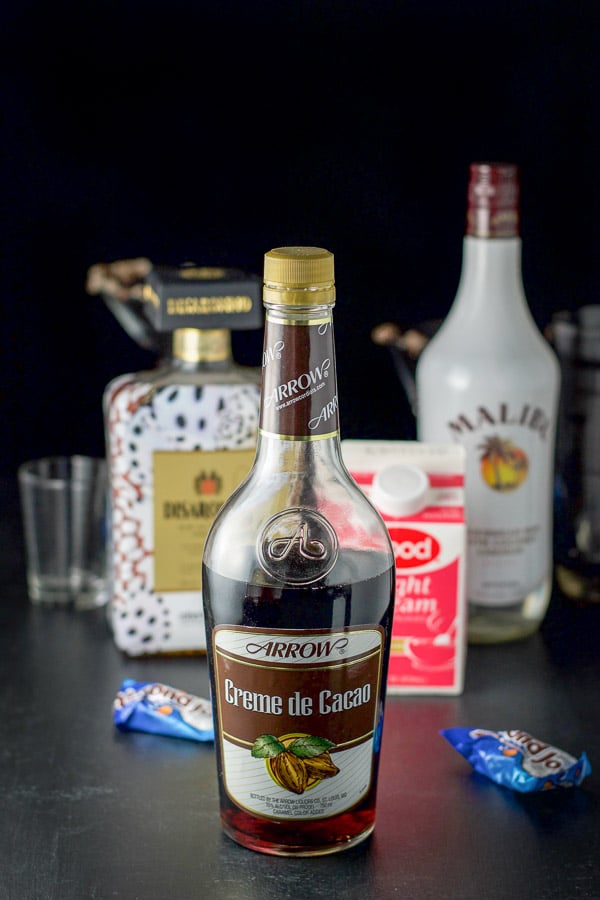 Creme de Cacao, coconut rum, Amaretto and light cream along with the glassware, shaker and almond joy bars on the table