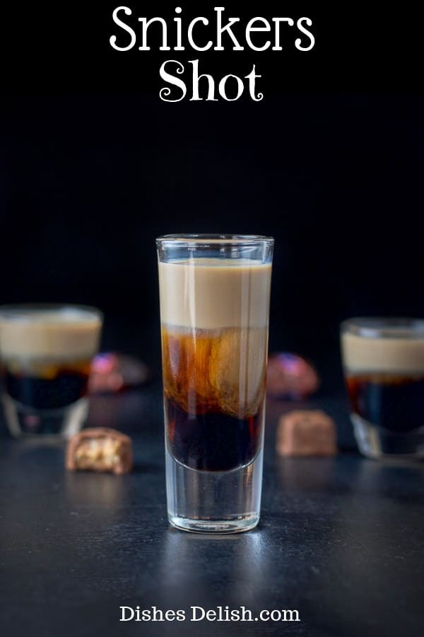 This Snickers shot has only three ingredients: Kahlúa, Frangelico and Baileys Irish cream! So delicious and reminiscent of the famous candy bar! #snickersshot #layeredshot #dishesdelish