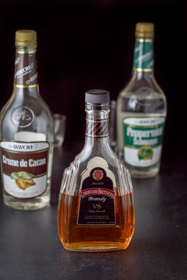 Brandy, Creme de Cacao and Peppermint schnapps on a table