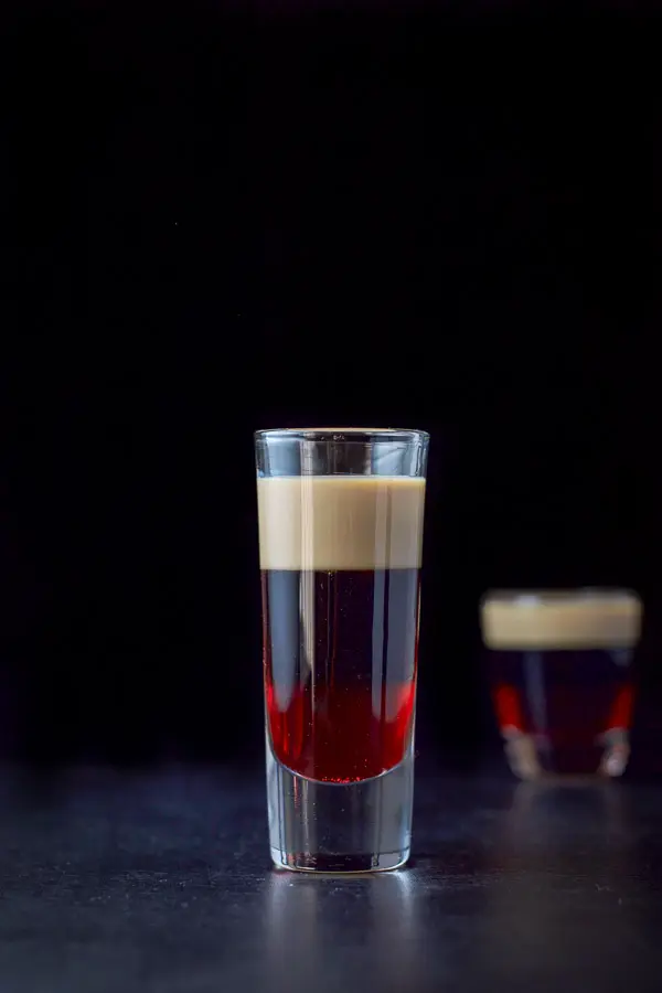 Vertical view of the layered shot with the tall glass in front of the shorter glass