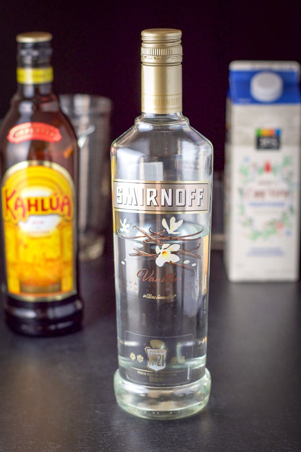 Smirnoff, Kahl&uacute;a, eggnog on the board with the shaker in the background