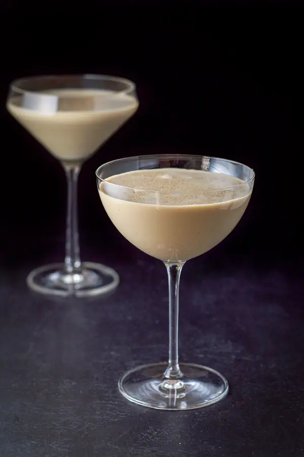 The chocolate eggnog drink poured in the glasses on a black board