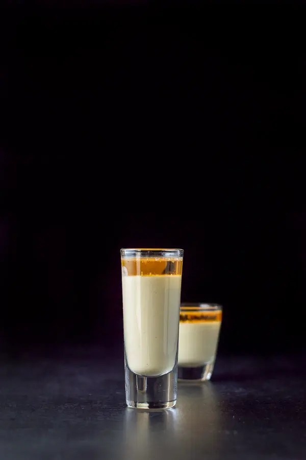 Vertical view of the layered shot with the tall glass in front