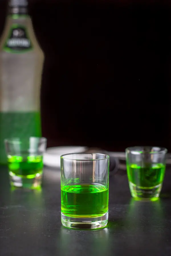Midori poured into the glasses with the bottle in the background