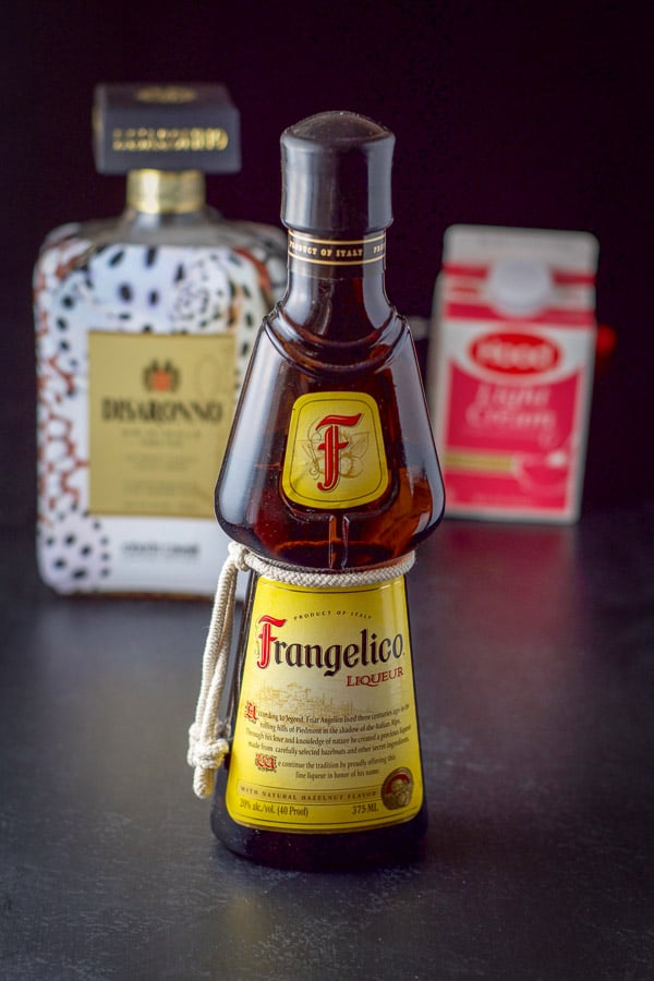 Frangelico, amaretto and light cream on a table
