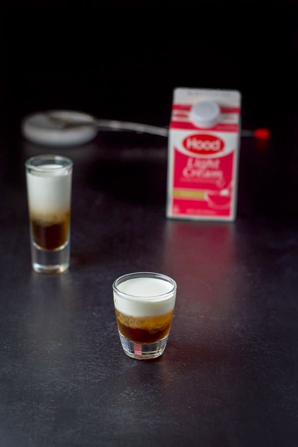 Light cream layered into the glasses with the cream in the background