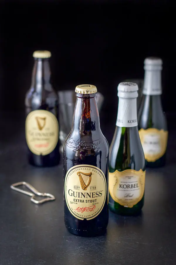 Guinness and champagne along with an opener on the table