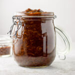 The prune spread in a jar with a side lid with a small jar also filled with the spread - square