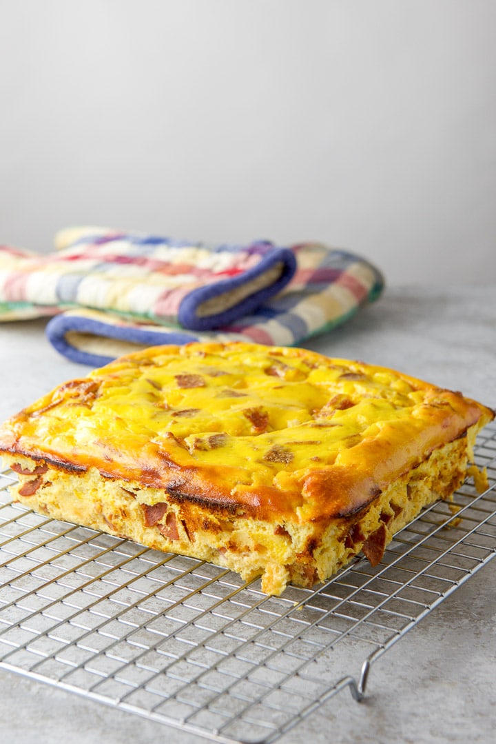 Egg casserole with the wax paper removed and cooling on a wire rack