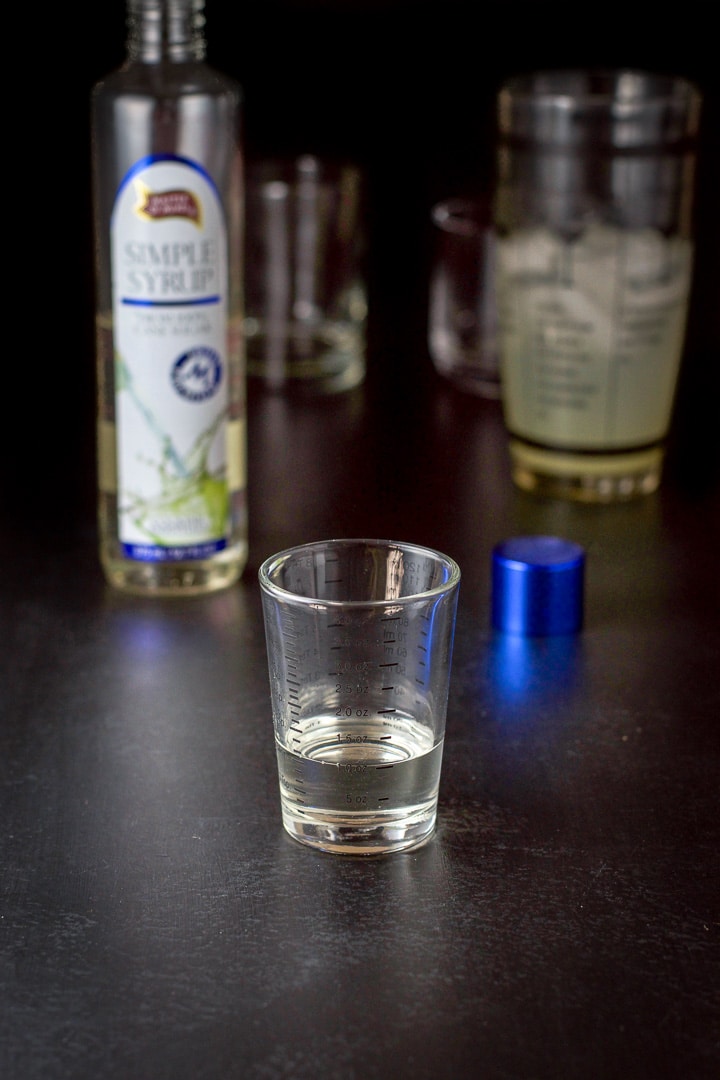 Simple syrup measured with the bottle, shaker and glasses