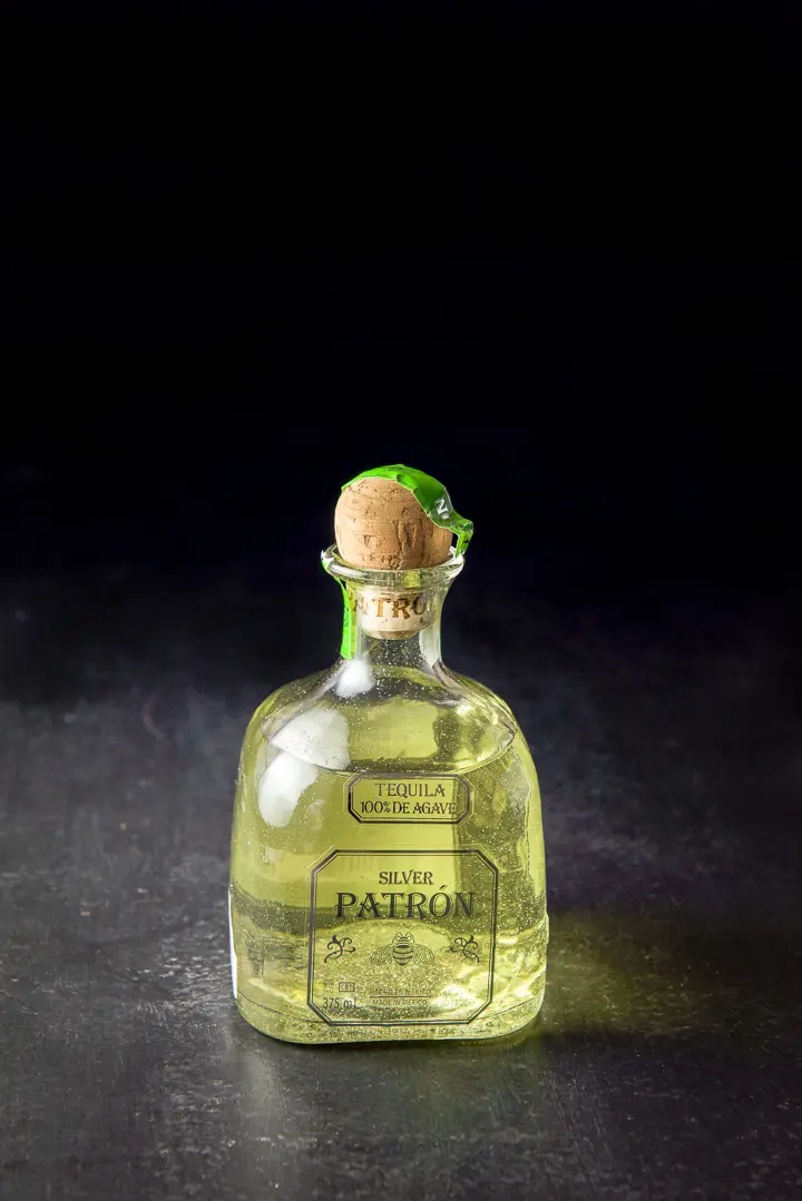 Infused tequila poured back into the bottle with the cork in it