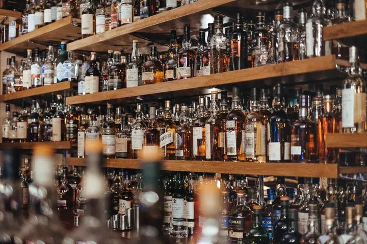 Photo with lots of liquor bottles on shelves