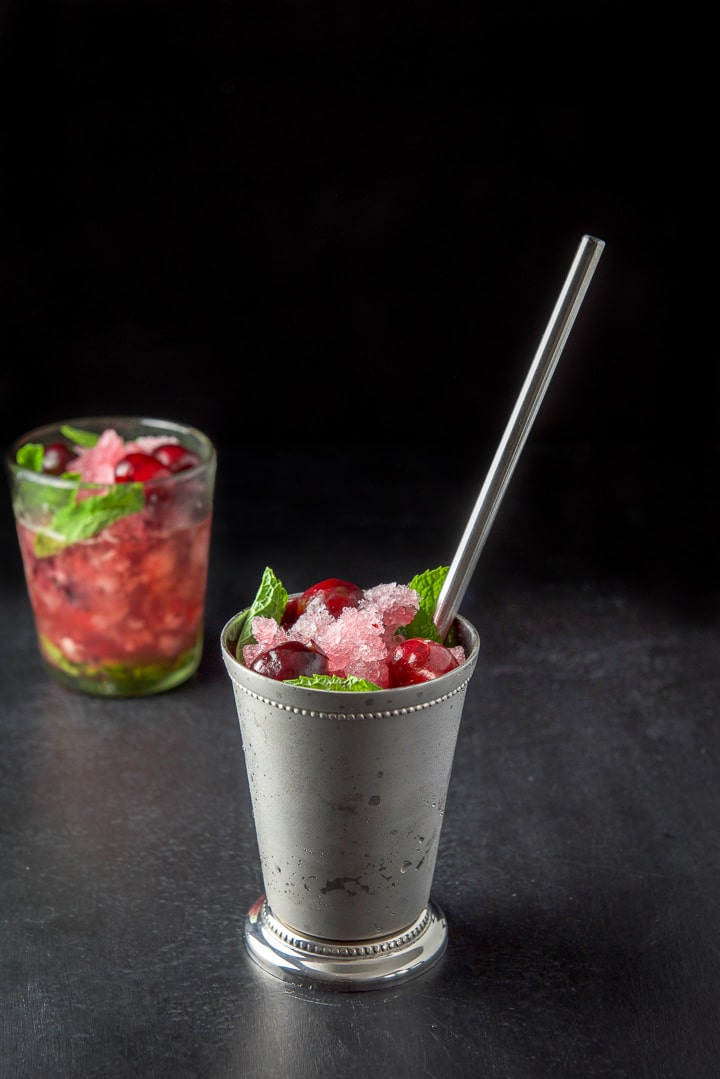 The cherry mint drink in the two glasses. The metal one in front with a metal straw in it