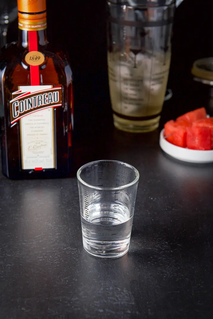 Cointreau measured out with the bottle in the background