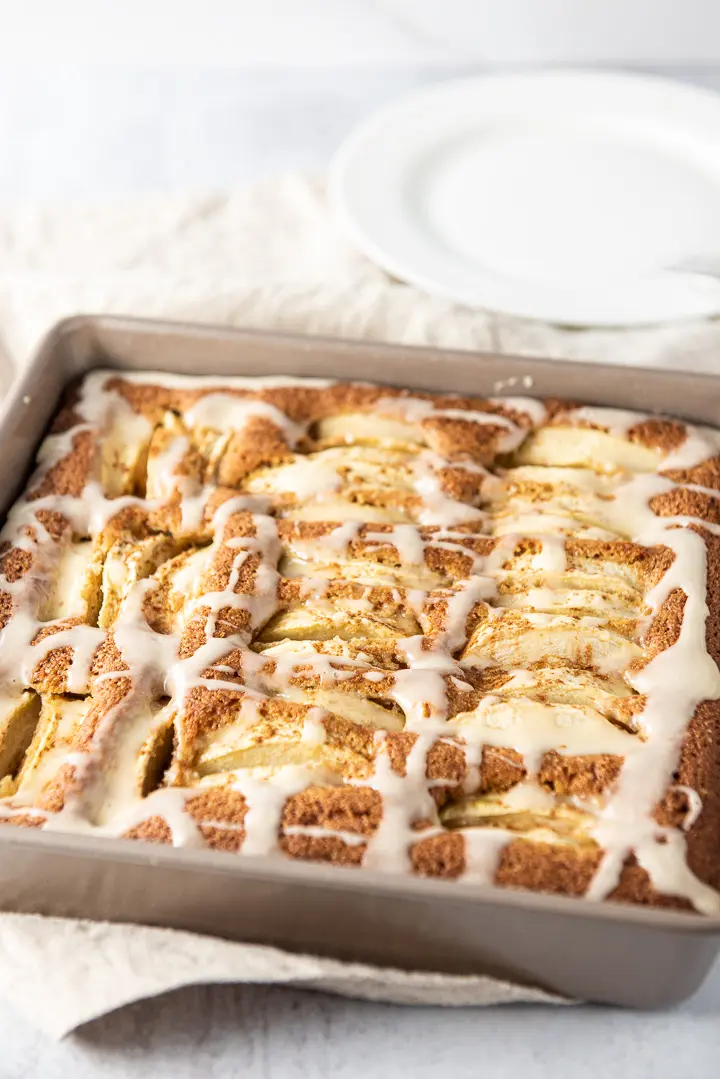 Newly frosted apple cake in a square pan