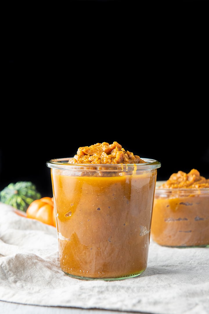 Vertical view of the pumpkin butter in two jars, one big one in front of a smaller one