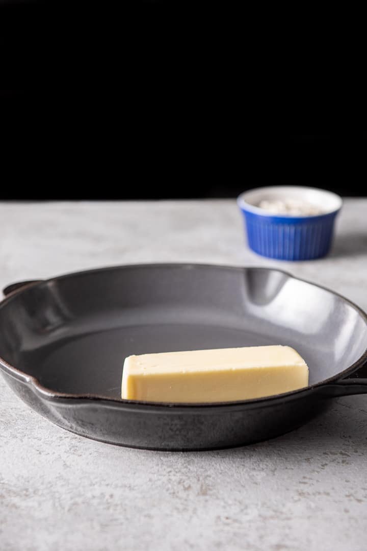 Butter in a pan and flour in the background