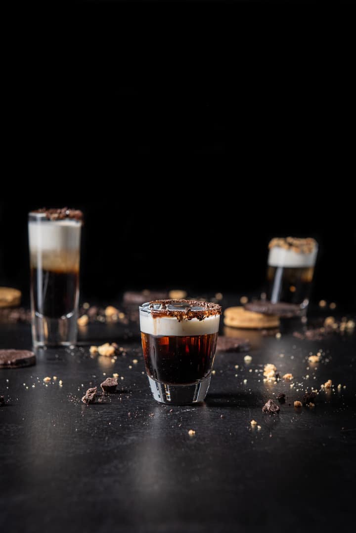 Vertical view of the short glass filled with the shot. The tall glass in on the left and the tilted glass is on the right