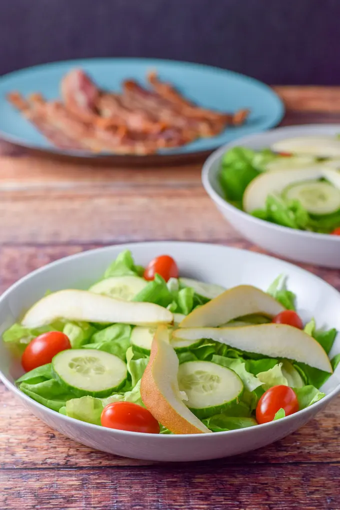 Pear slices added to the salad