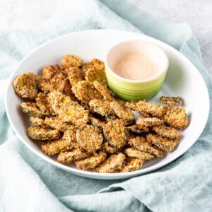 Deep white dish with fried pickles with dip - square
