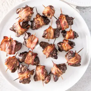 Overhead view of a plate of chicken livers wrapped in bacon - square