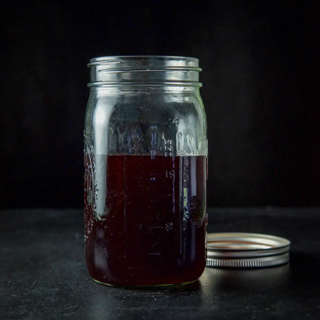 A jar of cherry infused bourbon - square
