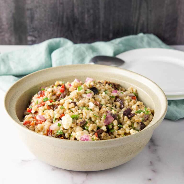 Farro salad in a beige bowl - square