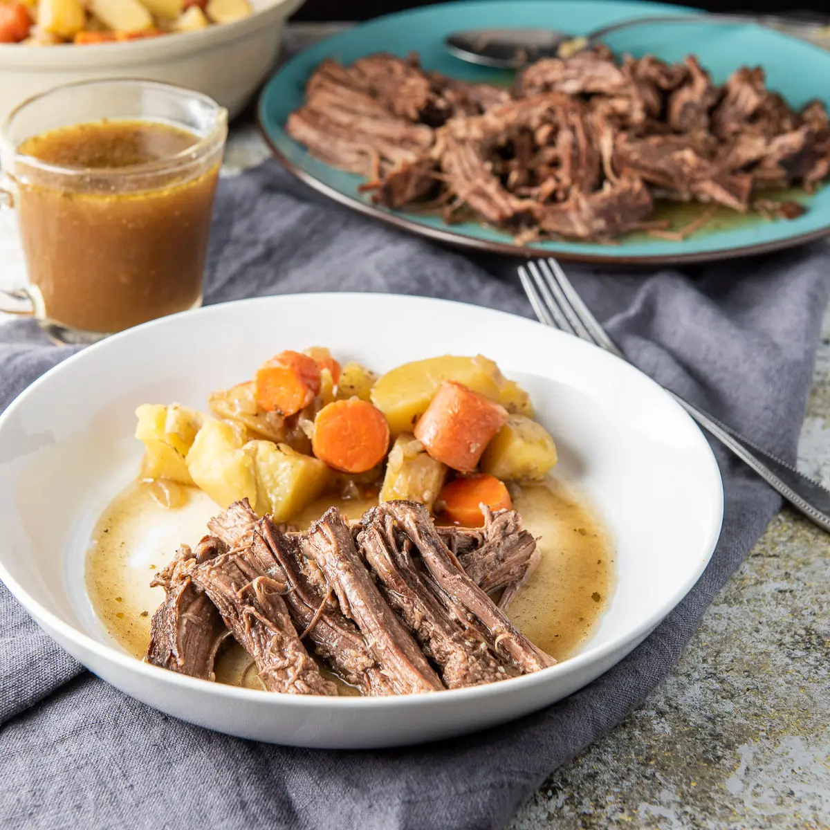 Square photo of the instant pot bottom round roast on a plate