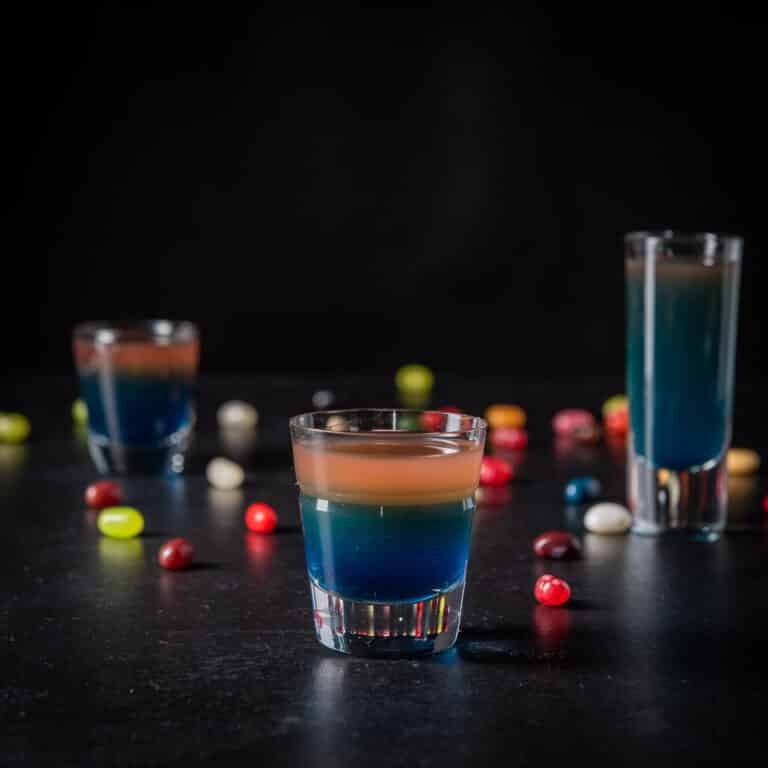 Square of the vertical view of the beveled glass in front of the two other glasses ad jelly beans on the table