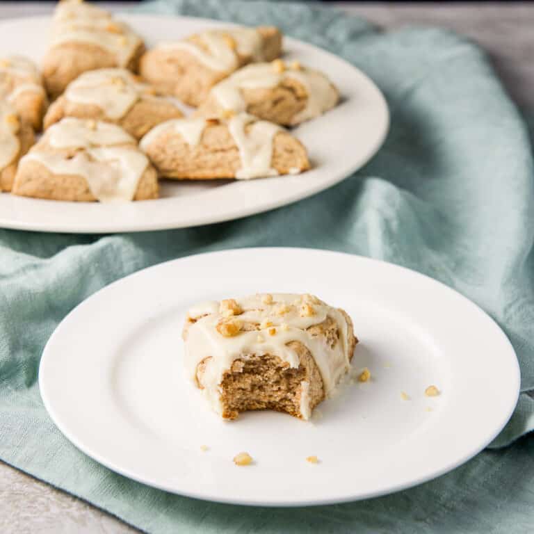 Square photo of the the scone with a bite taken out of it on a plate