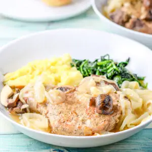 Moist pork chops on a plate with veggie - square