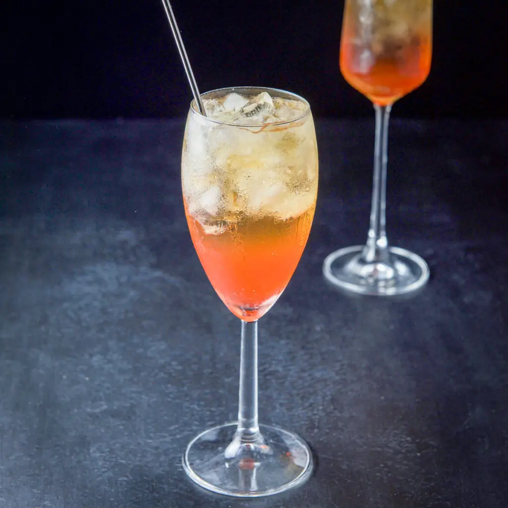 Classic orange cocktail in a white wine glass - square