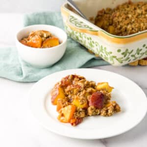 Plate of fruit crisp on a white round plate and in a bowl and baking dish - square
