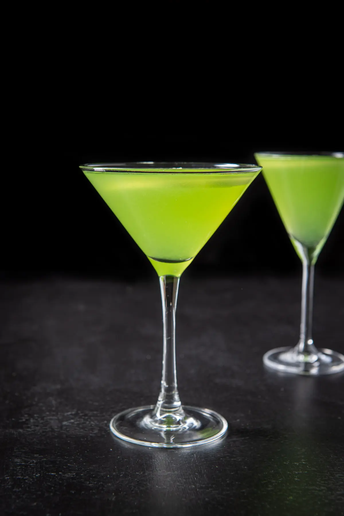 Vertical view of the green cocktail in the classic martini glass