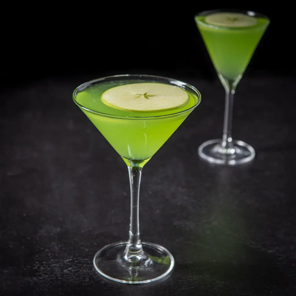 Sour apple cocktail in the classic martini glass