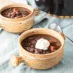 One crock of black bean soup with sour cream - square